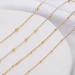 Macro detail of copper ball chain with gold finish for DIY jewelry and extensions