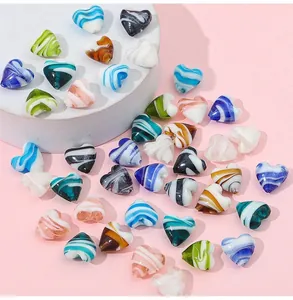 Macro detail of colorful striped heart glass beads for DIY jewelry making accessories