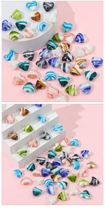 Macro shot of colorful striped glass heart beads with side drill holes for DIY jewelry making