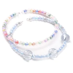 Macro detail of 4mm faceted glass beads in macaron gradient colors for DIY jewelry