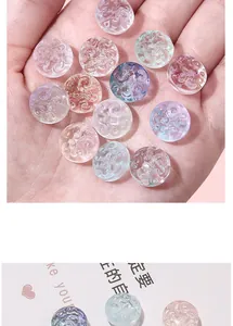Macro detail of transparent glass beads with intricate carved relief for DIY jewelry
