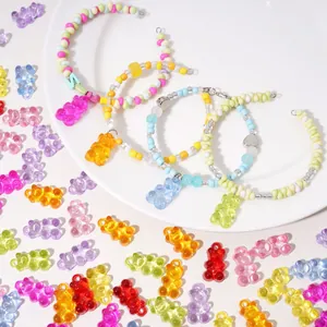 Five colorful candy acrylic bear charm beaded bracelets displayed on a white plate