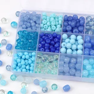 Blue aesthetic DIY bead set with various round and barrel beads in a plastic storage box