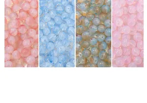 Detail of colorful round glass beads showing translucent texture for DIY jewelry making