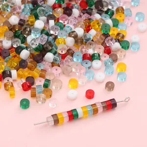Macro detail of colorful flat round glass beads for DIY jewelry with a metal needle tool
