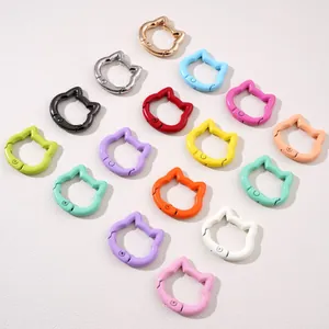 Cat head shaped spring keychains in multiple colors arranged in a creative heart shape