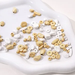 Macro shot of matte gold and silver textured irregular beads for DIY jewelry making