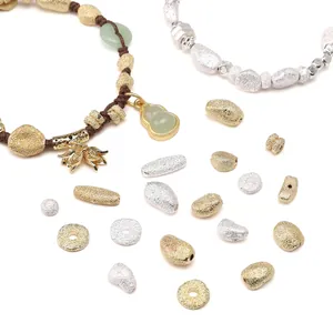 DIY handmade bracelet with frosted gold beads, jade-like stones and lotus charms on white backdrop