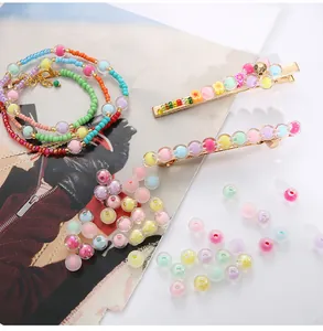 Macro detail of macaron acrylic beads and gold clips for DIY jewelry making