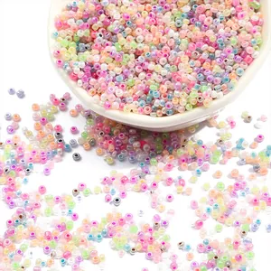 Assorted 2-4mm macaron glass seed beads in a white bowl for DIY jewelry making