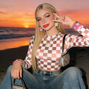 Close-up of long straight synthetic wig with middle part styled in a warm sunset beach setting
