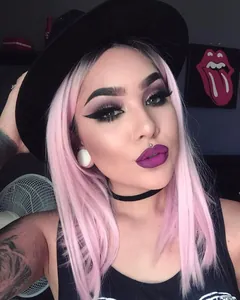 Close-up of pink long straight hair wig with gothic makeup and punk accessories