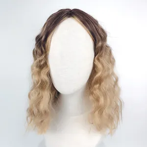 Close-up of ombre dark brown to blonde wavy synthetic wig with natural scalp parting