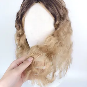 Detailed view of ombre dark brown to golden blonde long wavy synthetic wig on a model