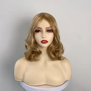 Golden brown wavy synthetic wig for women with long voluminous loose curls on a display head