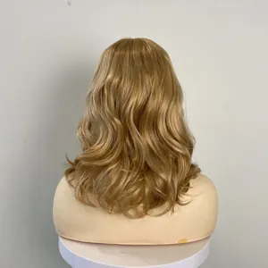 Rear view of a light blonde wavy wig with voluminous curls on a mannequin head