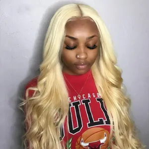 Long platinum blonde wavy wig with center part shown on model against gray background