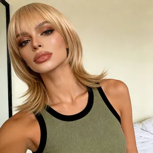 Detailed view of blonde medium-length wig with bangs and layered ends on a model