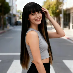 Outdoor close-up of long straight black ombre synthetic wig with bangs on a fashion model