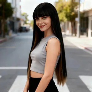 Close-up of long straight ombre brown wig with bangs shown on a model in sunlight