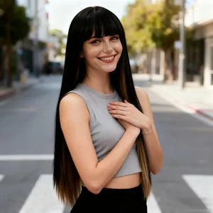 Detail of long straight black wig with bangs and light brown highlights in outdoor setting