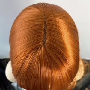 Macro view of the realistic scalp parting and ginger orange synthetic hair fibers