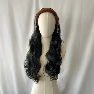 Detailed view of bohemian black wavy wig with brown velvet headband and gold tassels