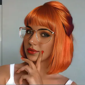 Detail of bright orange bob wig with straight bangs and inner buckle styling