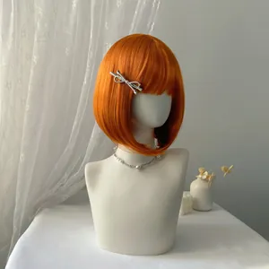 Short orange bob wig with flat bangs and internal curve on white mannequin