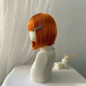 Short orange bob wig with bangs and a silver bow clip shown from a side profile