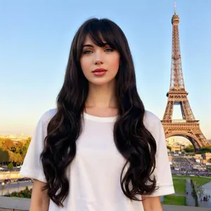 Long wavy black wig with bangs shown in front of the Eiffel Tower for a fashion look