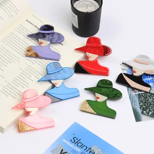 Flat lay of retro acrylic lady silhouettes pins in assorted colors on a lifestyle background