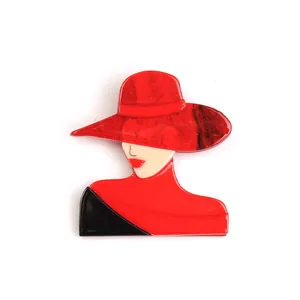 Modern acrylic brooch featuring an elegant woman in a red glitter hat and stylish silhouette