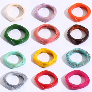 Set of 12 geometric resin bangles in solid colors and marble patterns for women