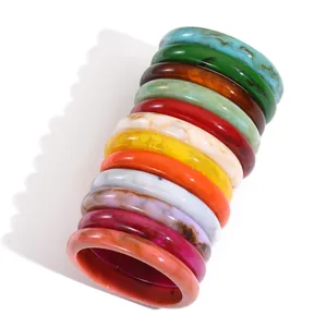 Set of 12 retro marble resin bangles in vibrant colors like turquoise and amber