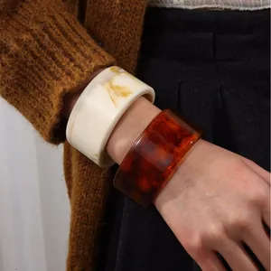 Retro style translucent resin wide bangles in cream marble and deep amber finish