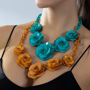 Bohemian acrylic rose flower necklace in vibrant blue and amber orange colors