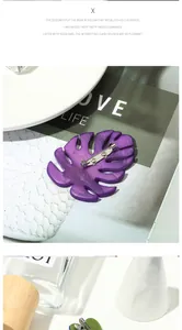 Detail of purple monstera leaf brooch with marble texture resin and secure metal pin
