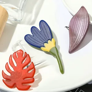 Artistic acrylic leaf and sunflower brooch set with vibrant red, blue and purple nature designs