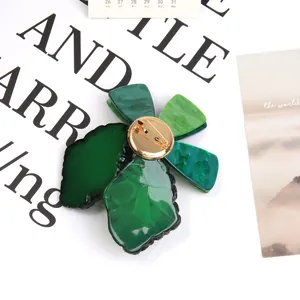 Chic green acrylic flower brooch with marble texture and gold pin on artistic card
