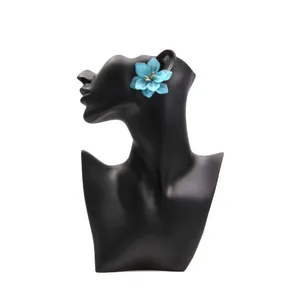 Elegant blue acrylic flower earrings with gold center on model, Korean style fashion