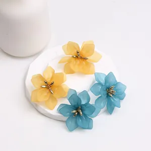 Minimalist flower earrings in blue and yellow acrylic with gold metal accents
