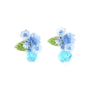 Handcrafted blue acrylic flower earrings with bell-shaped pendants on white background