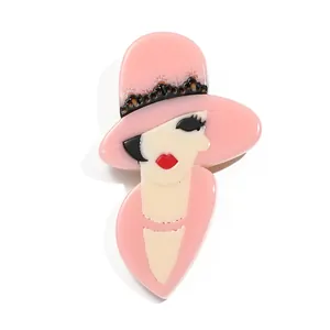 Chic acrylic lady brooch featuring a pink wide-brimmed hat with elegant black lace details