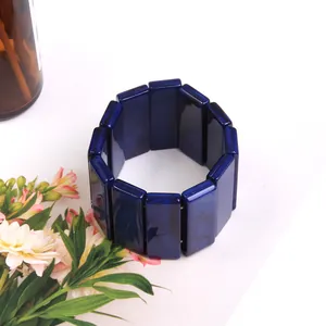 Deep blue wide resin stretch bracelet with marble texture on minimalist white background