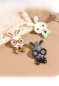 Three cute acrylic bunny brooches with glasses and bow ties on a travertine stone
