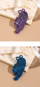 Detailed macro view of trendy leopard acrylic brooches in purple and blue marble textures
