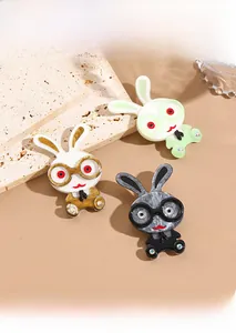 Close-up of acrylic cartoon bunny brooches with marble texture and rhinestone details