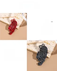 Macro detail of leopard acrylic brooches in red and grey with artistic spot patterns