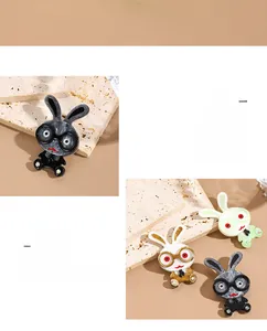 Close-up of marble texture acrylic cartoon rabbit brooch with glasses in various colors